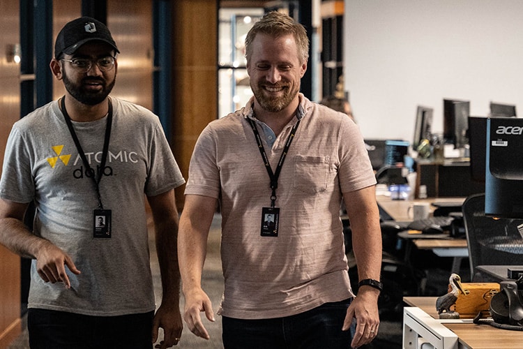 Two-Men-Walking-down-hallway-smiling